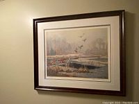 Frontal view of framed print showing marsh landscape with geese, double mat and dark red wood frame