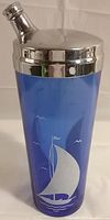 Photo of the 1930's sailboat cobalt depression glass cocktail shaker with silver-plate top showing the cobalt blue glass body and silver-plated lid with spout