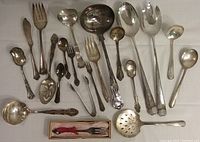 Photo of 21 silver-plated serving utensils including ladles, spoons, forks, modern salad set, and boxed pickle fork