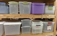 Shelves with multiple medium plastic storage bins in translucent colors such as purple, green, and clear, some with lids.