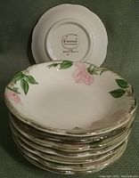 Stack of eight Franciscan Desert Rose 5-inch bowls showing the floral design and backstamp on bottom.