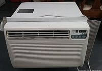 Front view of a white Kenmore window air conditioner showing the air vent, control panel with buttons and digital display, and general condition.