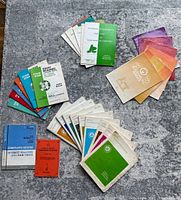Multiple Royal Conservatory of Music books spread on surface including sight reading, ear tests, technical books, and colorful music workbooks.