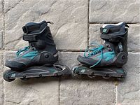 Pair of women's inline roller skates in black with teal accents, size 8 US, positioned side-by-side.
