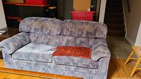 Front view of the two cushion hide-a-bed couch showing upholstery pattern, cushions, and overall condition