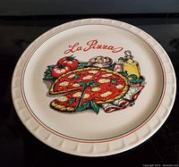 12-inch round ceramic or glass tray with 'La Pizza' text and pizza illustration
