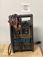 Front view of Nautilus 12V 10Amp battery charger with clamps and cables coiled on top.