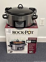 Crock-Pot slow cooker on top of original box showing product and packaging.