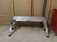 Front view of the aluminum foldable work bench with Mastercraft logo.
