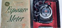 Photo showing original GE Exposure Meter box with the meter device placed inside red foam insert.