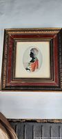 Framed early Victorian silhouette artwork of a lady in profile, showing the entire frame and artwork within.