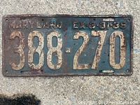 Metal license plate from 1939 marked 'MARYLAND EX 3-31-39' with embossed number 388-270, showing surface rust and wear.