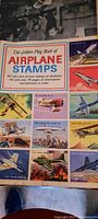 Front cover of the vintage airplane stamps book showing colorful airplane stamp illustrations and title.