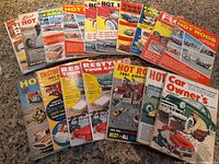 Lot of 18 vintage automotive magazines from 1959-1962, fanned out showing colorful covers with classic hot rods and custom cars.