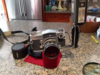 Miranda Sensorex camera with attached Soligor lens and external flash on kitchen counter.