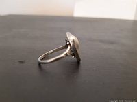 Side profile of vintage sterling silver ring showing band and setting detail.