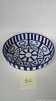 Blue and white ceramic salad bowl with Art Deco geometric patterns, showing the top and sides.