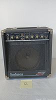 Front view of Holmes Tech Series electric guitar amplifier showing overall device and speaker grille.