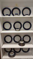 Full set of plates and cups arranged on shelving showing size and design