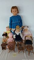 Full view of all dolls and furniture included in the lot, showing size variations and types of items.