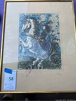 Full view of framed artwork depicting a woman riding a horse surrounded by abstract patterns with blue and green tones.