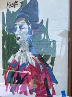 Full view of framed Picasso print showing figure with blue hat and colorful attire in abstract style.