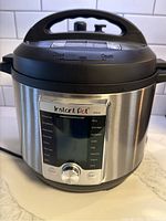 Front view of Instant Pot Ultra electric pressure cooker showing the display panel and control dial.