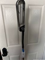 Close-up of the lamp's light head showing the twin fluorescent tubes inside a rectangular housing.