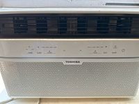 Close-up of front control panel with Toshiba brand and digital display buttons visible.