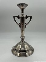 Front view of the silver centrepiece showing the ornate Art Nouveau style handles and engraved floral detail on the base.