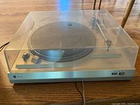 Full view of Dual CS 508 turntable with closed transparent dust cover, showcasing metal housing and controls.