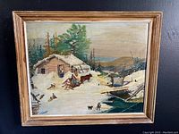 Full view of framed original painting showing snowy log cabin scene with people, horse, and winter details.