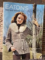 Front cover of vintage Eaton's Fall and Winter 1975 catalogue showing a woman in a fur-collared knit jacket.