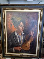Full view of the framed oil painting depicting a boy holding a violin.