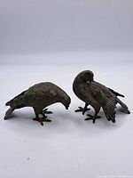 Pair of cast iron birds, side view showing shape and patina