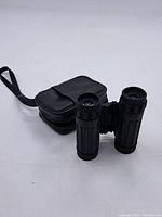 Tasco 8x21 binoculars with carrying case on white background.