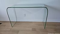 Front view of glass console table showing curved sides and top