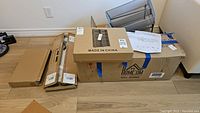 Boxed Homecom cubby cabinet and wall mount organizers in packaging on floor