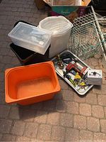 Wide view of all items including containers, wire baskets, and metal tray with tools