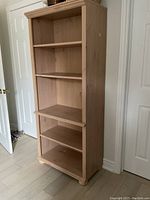 Front view showing five shelves and oak finish