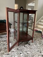 Open front view showing interior with two glass shelves inside mahogany cabinet.