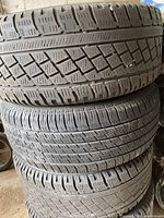 Stack of four used tires showing tread condition for size 225/55/R16