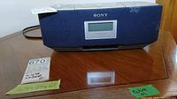 Front view of blue Sony radio/CD player with visible Sony logo and digital display.