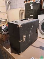 Exterior of closed black tool box on table