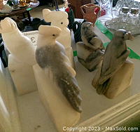 Photo showing all three stone bird book ends from different angles to capture details in carving and stone color.