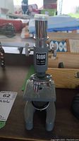 Front view of Lumex No. 5DSEL microscope showing eyepiece, stage, and focusing knobs.