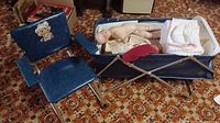 Child's blue vinyl folding chair and matching doll crib with dolls inside
