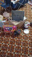 Photo showing Lite Brite Mickey Mouse box, slide viewfinder, box with assorted Lego bricks, and small containers.
