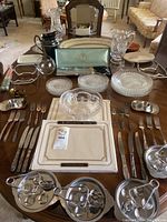 Full view of collection arranged on table including glassware, silverware, placemats, and serving dishes.