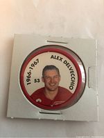 Front side of the hockey coin showing Alex Delvecchio's photo, name, number 53, and season 1966-1967.